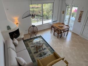 a living room with a couch and a table at Roberts Villa in Dhërmi