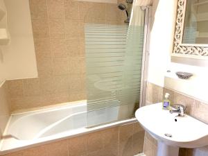 a bathroom with a tub and a sink and a shower at Maison Girasol Sleeps 4 w Pets On Request in Eymet +3 photos