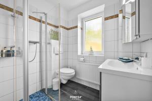 a white bathroom with a toilet and a sink at Ferienwohnung Lee Dagebüll in Dagebüll