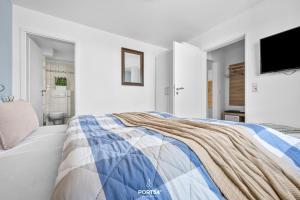 a white bedroom with a blue and white bed at Ferienwohnung Luv Dagebüll in Dagebüll