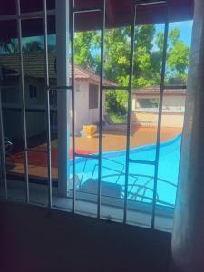 a view of a swimming pool through a window at Tambell Haven in Runaway Bay