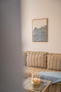 a living room with a couch and a glass table at Aphrodite Breeze Paphos Gardens in Paphos +26 photos