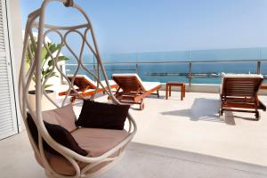 a porch with chairs and a hammock on a balcony at Plus Fariones Habitat in Arrecife