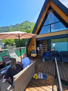 two people sitting on the deck of a boat at Omorika Perućac Splav in Gaočići