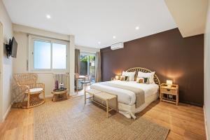 a bedroom with a large bed and a large window at Hôtel Comté de Nice in Beaulieu-sur-Mer