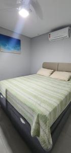 a bed in a white room with avertisement at Casa em São Mateus - Guriri in São Mateus +20 photos