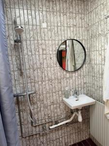 a bathroom with a sink and a mirror at Room for rent Solskrænten in Vorgod +20 photos