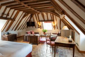 a bedroom with a bed and a living room at Hostellerie De Levernois in Levernois