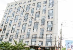 a large white building with many windows on it at Stylish 10th Floor Studio with great Views ,Fast Wi-Fi and Secure in Nairobi