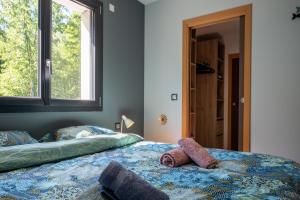 a bedroom with a bed with a stuffed animal on it at Superbe maison au calme - Piscine in Chantraine +28 photos