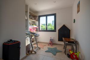 a room with a desk and a window and a table at Superbe maison au calme - Piscine in Chantraine