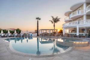 a large swimming pool in front of a hotel at Arkadia Hotel in Kypseli