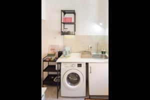a kitchen with a washing machine and a sink at Casa Teresa in Rome +32 photos
