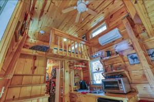 a kitchen with wooden walls and a ceiling at Peaceful Forest Tiny Home in Newport +18 photos