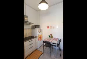 a kitchen with a table and a small table and chairs at Casa Teresa in Rome