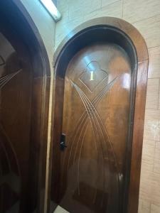 a wooden door with a cat drawn on it at شقةكبيرة 4 غرف نوم وصالة بلكونه Large apartment with 4 bedrooms, a living room and a balcony in Taif +5 photos