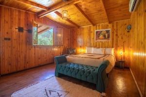 a bedroom with a bed and a couch in a room at Dar l'eau Vive in Bine el Ouidane +191 photos