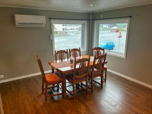 a dining room with a wooden table and chairs at Bedify Lodge Sokndal in Sokndal