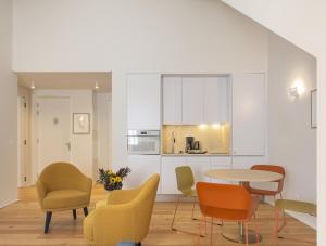 a living room with a table and chairs at LSA Estrela by Numa in Lisbon