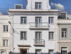 a white building with balconies on the side of it at LSA Estrela by Numa in Lisbon