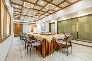 a large conference room with a long table and chairs at Treebo Aaram Orchard in Ahmedabad