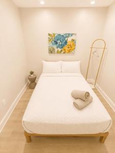 a bedroom with a large white bed with a towel on it at Villa Shores in Miami