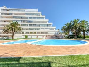 a swimming pool in front of a large building at Holiday 3401 in Roses