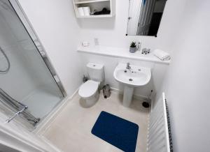 a bathroom with a toilet and a sink and a shower at Blue Diamond in Milton Keynes