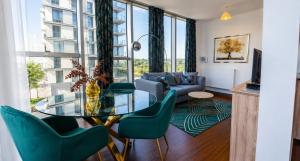 a living room with a glass table and chairs at Blue Diamond in Milton Keynes