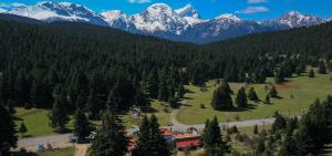 a view of a mountain range with snow covered mountains at The Sam's house in Panouryiás