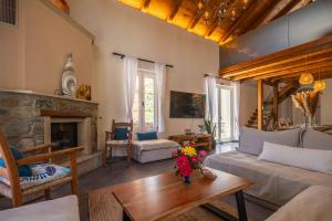 a living room with a couch and a fireplace at Villa 4 DESTINA in Élos