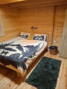 a bedroom with a bed in a log cabin at The Sam's house in Panouryiás