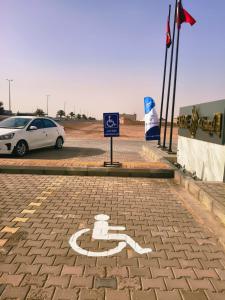 a white car is parked in a parking lot at إليت الجامعة -Elite Served Apartments - Hafar Al-Batin in Hafr Al-Batin