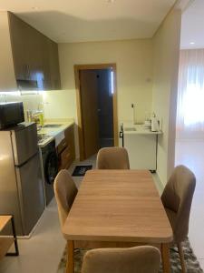 a kitchen with a table and chairs in a room at Rabat Easy Access ll in Rabat