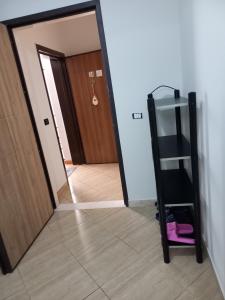 a mirror reflection of a hallway with a ladder at Flodril Appartment in Durrës +6 photos