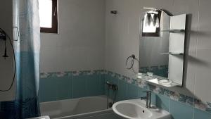 a bathroom with a sink and a bath tub at Briz in Varna City +8 photos