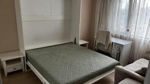 a small bedroom with a bed and a window at Briz in Varna City