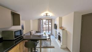 a kitchen and living room with a couch and a table at Maison Montagne Mzaar in Kfardebian