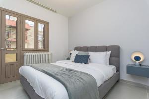 a bedroom with a large bed and a window at Maison Montagne Mzaar in Kfardebian