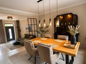 a dining room with a wooden table and chairs at Ferienwohnung Marina in Wiesmoor