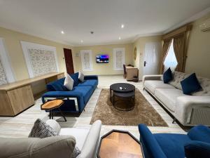 a large living room with couches and a table at Visa Karena Hotels in Port Harcourt