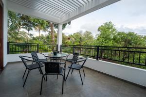 a patio with a table and chairs on a balcony at 79 by TerraLume in Nugegoda