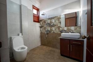 a bathroom with a toilet and a sink at 79 by TerraLume in Nugegoda +50 photos