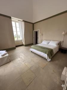 a large bedroom with a bed and a large window at GH Masseria Monet in Monopoli
