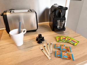 a counter with a toaster and a cup of coffee at " L'Oratoire Mansardé " Linge fourni - Wifi - TV in Lagardelle-sur-Lèze