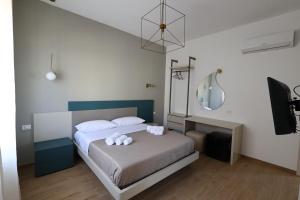 a bedroom with a bed with two stuffed animals on it at Ferries apartament in Trapani