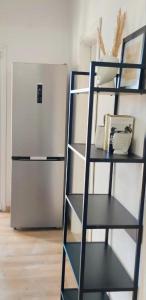 a black book shelf next to a refrigerator at Ina's apartments in Lefkimmi +39 photos