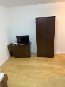 a room with a dresser and a cabinet with a television at Motel Victoria in Zvornik +14 photos