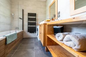 a bathroom with a tub and a sink and a bath tub at Chalet Nanouk - exposé plein sud in La Salle-les-Alpes