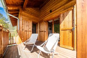 two chairs sitting on the deck of a cabin at Chalet Nanouk - exposé plein sud in La Salle-les-Alpes +19 photos